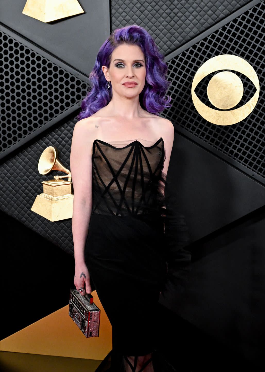 kelly osbourne sports purple hair and a strapless black floor length dress