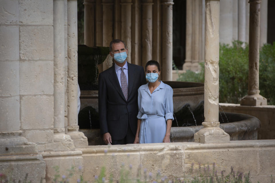 Spain's King Felipe VI and Queen Letizia visit the Royal Monastery of Poblet, northeastern Spain, Monday, July 20, 2020. Hundreds of Catalan independence supporters are protesting Monday the visit of King Felipe VI and Queen Letizia to the northeastern region as part of a royal tour across Spain that is meant to bolster spirits amid the coronavirus pandemic. The visit comes as a barrage of media leaks have revealed how the king's father, former monarch Juan Carlos I, allegedly hid millions of untaxed euros in offshore funds. (David Zorrakino/Europa Press via AP)