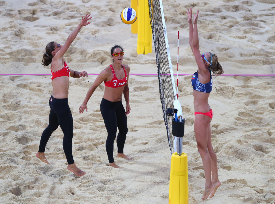 LONDON, ENGLAND - JULY 31: Annie Martin of Canada pushes the ball over the net during the Women's Beach Volleyball Preliminary match between Canada and Russia on Day 4 at Horse Guards Parade on July 31, 2012 in London, England. (Photo by Ryan Pierse/Getty Images)