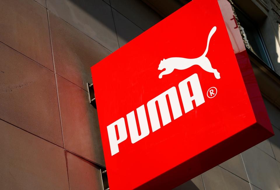 FILE PHOTO: The logo of German sports goods firm Puma is seen at the entrance of one of its stores in Vienna, Austria, March 18, 2016.   REUTERS/Leonhard Foeger