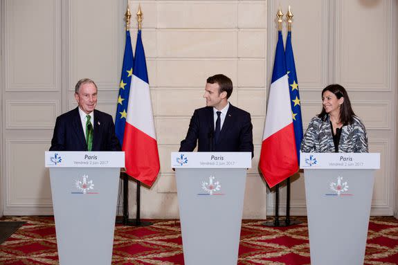 Michael Bloomberg, left, with France's President Emmanuel Macron and Paris Mayor Anne Hidalgo. Bloomberg told French leaders the U.S. remains committed to the Paris treaty.