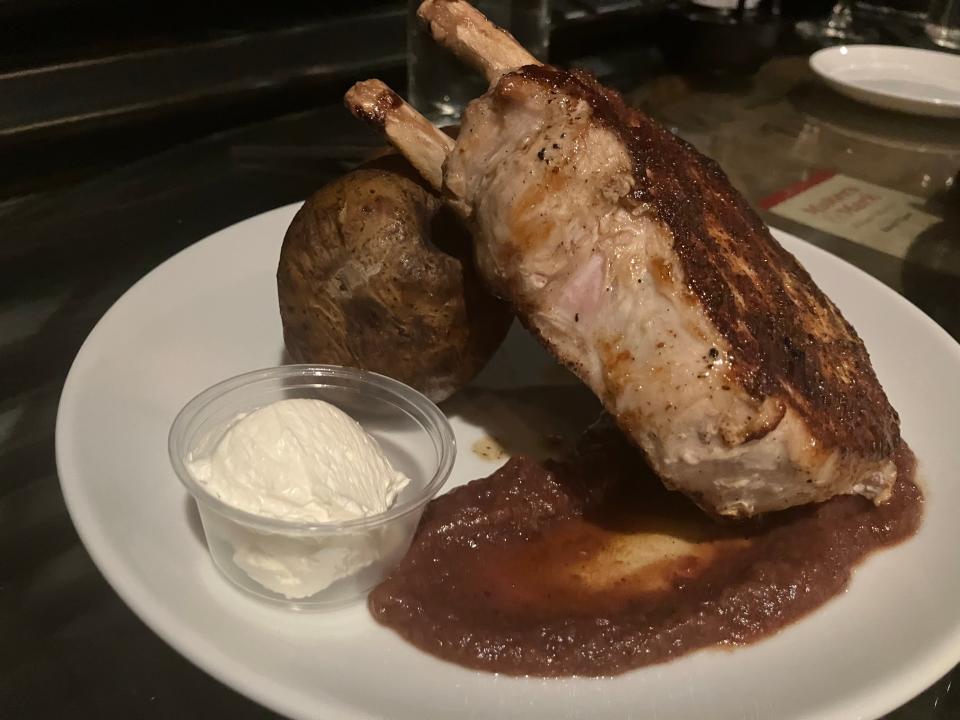 35º Brix serves its 16-ounce double bone Frenched pork chop with bourbon jam and a large baked potato.