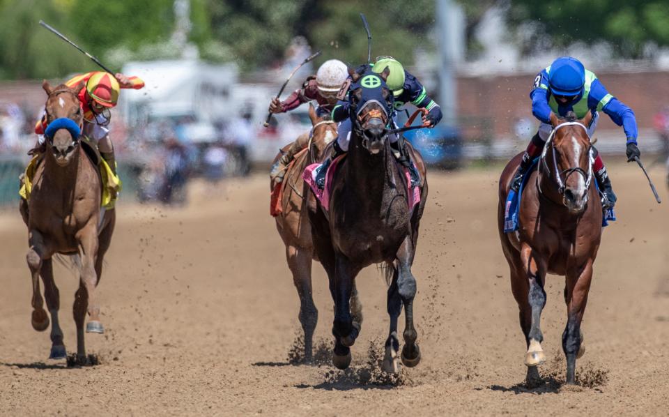 Jackie's Warrior, center, with jockey Joel Rosario aboard, wins the Pat Day Mile at Churchill Downs on Kentucky Derby Day.