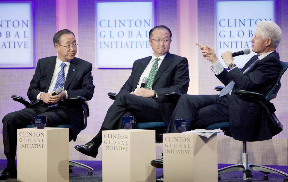 Ban Ki-Moon, left, Secretary-General of the United Nations, and Jim Yong Kim, center, President of the World Bank, listen to former U.S. President Bill Clinton during a panel discussion at the Clinton Global Initiative, Sunday, Sept. 23, 2012 in New York. (AP Photo/Mark Lennihan)