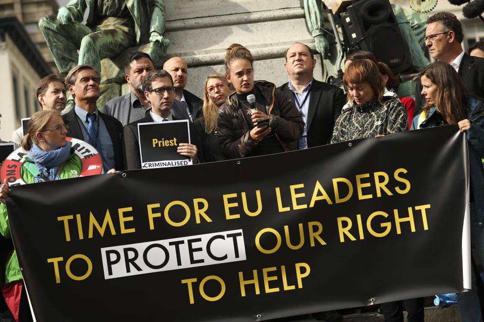 German boat captain Carola Rackete, center, talks during a protest outside the European Parliament in Brussels, Thursday, Oct. 3, 2019. The captain of a humanitarian rescue ship arrested for docking the vessel in an Italian port without authorization is taking aim at the European Union for outsourcing the handling of migrants crossing the Mediterranean to conflict-ravaged Libya. (AP Photo/Francisco Seco)