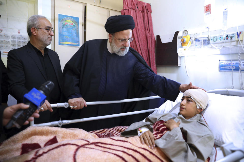 In this photo released by the Iranian Presidency Office, Iranian President Ebrahim Raisi visits a boy who was wounded in Wednesday's bomb explosion in the city of Kerman about 510 miles (820 kms) southeast of the capital Tehran, Iran, Friday, Jan. 5, 2024. Iranian officials tried Friday to link Israel and the U.S. to an Islamic State group-claimed suicide bombing, seeking to intertwine the assault with wider Middle East tensions from the Israel-Hamas war. (Iranian Presidency Office via AP)