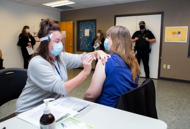 A health worker administers a vaccine on Vancouver Island at a clinic in January 2021.