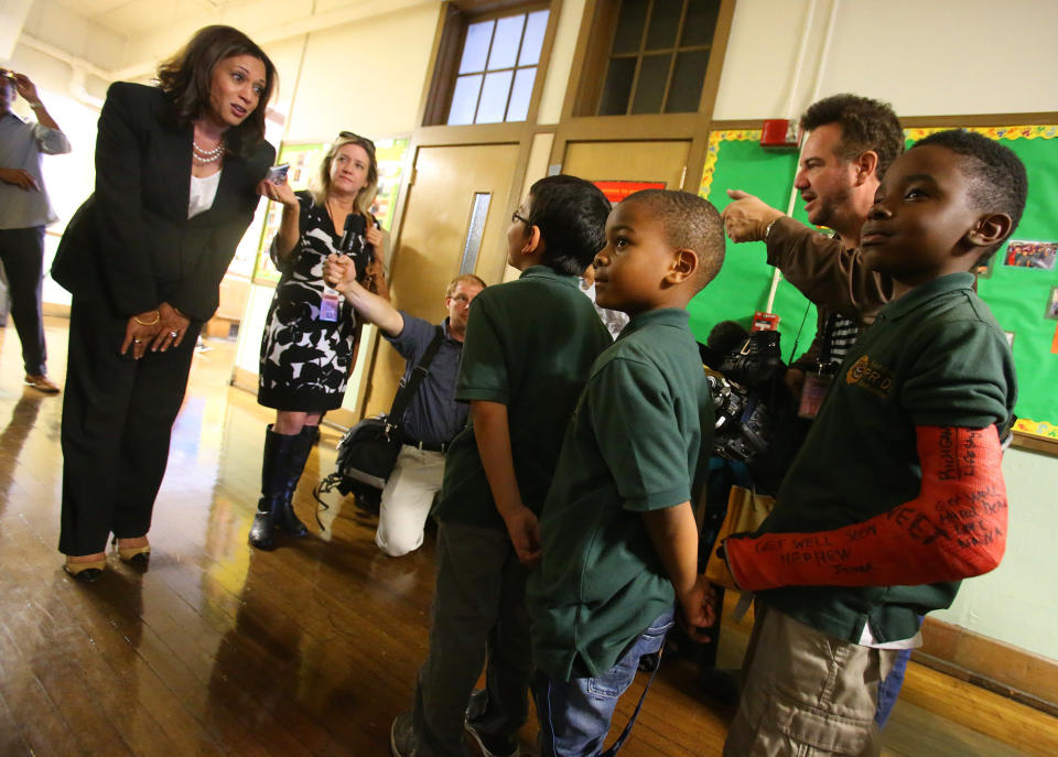 Harris, who was the attorney general for California at the time, talks with students at the East Oakland Pride Elementary School in Oakland on Sept. 4, 2014. She sponsored legislation to help local school districts and communities address California's elementary school truancy crisis. (Photo: MediaNews Group/The Mercury News via Getty Images via Getty Images)