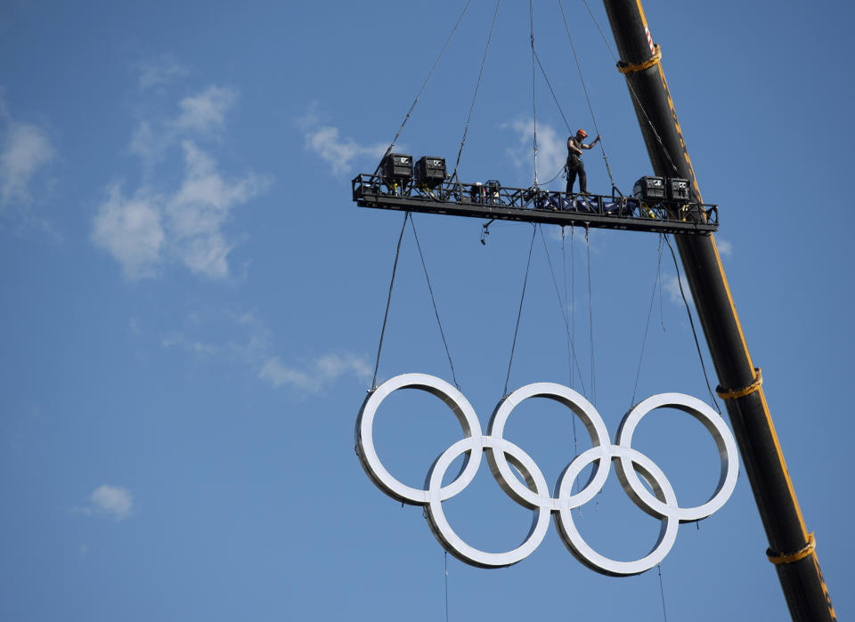 Olympic rings are craned into position at the Obelisk, in Buenos Aires, Argentina, Thursday, Oct. 4, 2018, two days ahead of the III Youth Olympic Summer Games. For the first time in modern Olympic history the event will not take place in a stadium but outdoors and will be open to all members of the public. (Joel Marklund/OIS/IOC via AP)