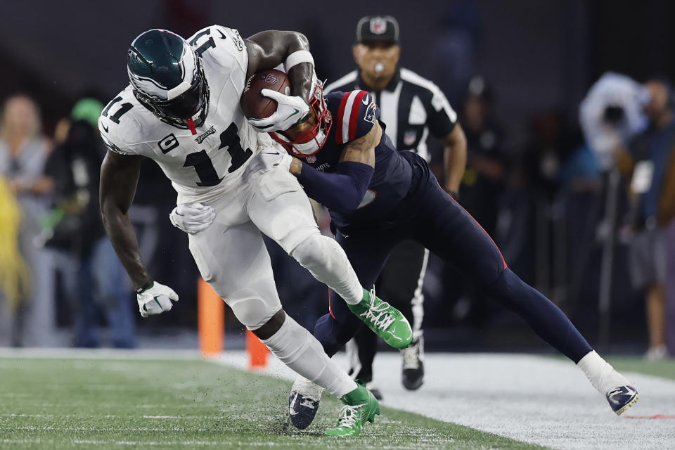 Philadelphia Eagles wide receiver A.J. Brown (11) is pulled out of bounds by New England Patriots linebacker Ja'Whaun Bentley in the second half of an NFL football game, Sunday, Sept. 10, 2023, in Foxborough, Mass. (AP Photo/Michael Dwyer)