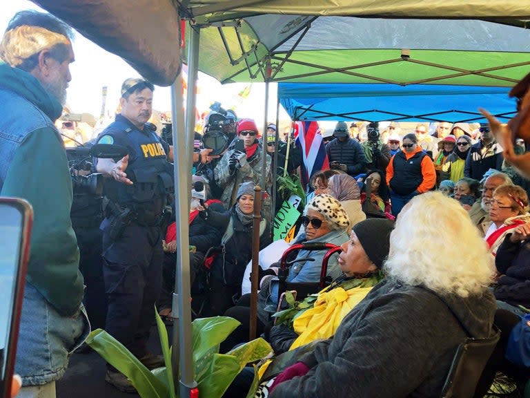 A group of elderly demonstrators have been arrested as thousands of protesters tried to stop the construction of a telescope on a mountain considered sacred to some Native Hawaiians,Hawaii county managing director Wil Okabe said about 2,000 people packed the base of the state’s highest peak Mauna Kea after the arrests, more than three times the number of protesters who had shown up in previous days.Police in riot gear temporarily lined the road to the top of the Big Island mountain, which is valued by astronomers for its consistently clear weather and minimal light pollution, and the site for the £1.12bn Thirty Metre Telescope, expected to be one of the world’s most advanced, allowing scientists to study the period just after the big bang.Protest leader Kealoha Pisciotta told the Associated Press that police took away about 30 elders who were prepared to be arrested as they blocked the road.“They’re taking our kupuna,” Ms Pisciotta said, using the Hawaiian word for elders and sobbing. Around her, people sang “Hawaii Aloha”, a Hawaiian song that is common at events.Some of the elders being arrested used canes and strollers to walk, while others were taken in wheelchairs to police vans. Those who could walk on their own were led away with their hands in zip ties.State spokesman Dan Dennison said 33 people were arrested, given citations and released.Walter Ritte, one of the protesters arrested, said he was driven down the mountain and later went back to the base of Mauna Kea.Hawaii Governor David Ige signed an emergency proclamation giving law enforcement agencies the power to close off areas and restrict access on Mauna Kea.The state had not decided whether to remove protesters from the mountain but that is one option the proclamation makes available, Mr Ige said.“We’ve been patient in trying to allow the protesters to express their feelings about the project,” Mr Ige said. “We are taking steps to assure the rights of those in the project to get the project moving.”The governor said the police has been patient and respectful towards protesters. He said protesters are illegally occupying roads and highways.Native Hawaiian protesters and other opponents of the telescope say they are concerned that construction will desecrate and damage the mountain.The project has been delayed by years of legal battles and demonstrations. Last year, the Hawaii supreme court ruled that telescope officials had legally obtained a permit, clearing the way for construction to begin.But protesters are still fighting at the mountain and in court.Kaho’okahi Kanuha, a protest leader, told reporters that efforts to stop the telescope were about protecting Hawaii’s indigenous people.“This is about our right to exist,” he said. “We fight and resist and we stand, or we disappear forever.”But other Native Hawaiians say they do not believe the project will desecrate Mauna Kea.Most of the cultural practices on the mountain take place away from the summit, said Annette Reyes, a Native Hawaiian from the Big Island.“It’s going to be out of sight, out of mind,” she said.Authorities closed the road to the mountain on Monday to allow construction to begin, attracting hundreds of protesters who formed their own roadblocks.The blockade forced astronomers to stop operating 13 existing telescopes on the mountain on Tuesday.Dozens of researchers from around the world will not be able to gather data and study the sky.Observations will not resume until staff have consistent access to the summit, which is needed to ensure their safety, said Jessica Dempsey, deputy director of the East Asian Observatory, where one of the existing telescopes is housed.Associated Press