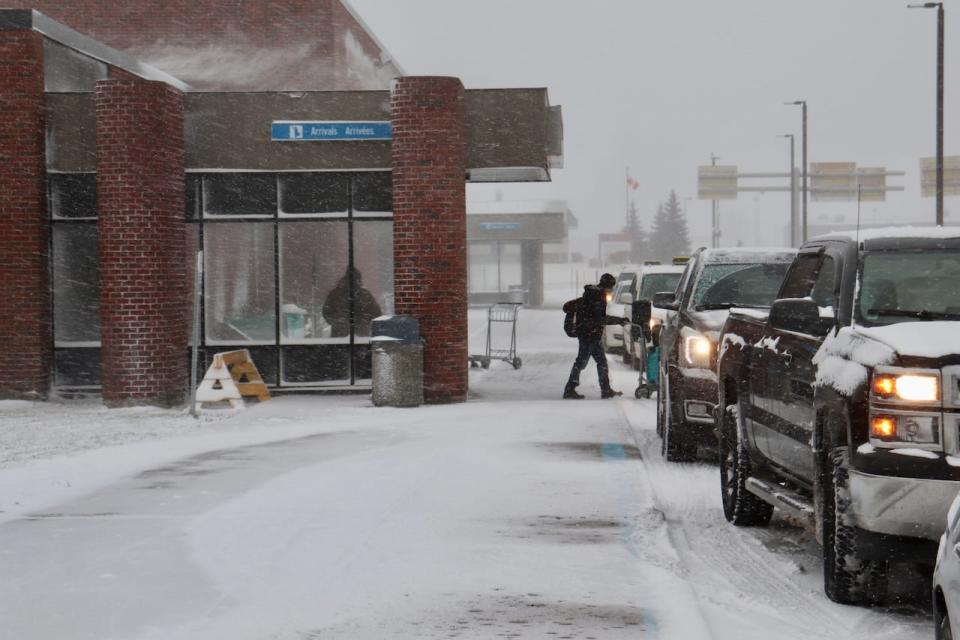 Various pictures in poor winter weather conditions including plans, people arriving and a plow. Taken 07 Jan 2022.