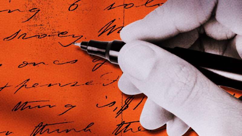 A hand with a pen writes in cursive on an orange page.