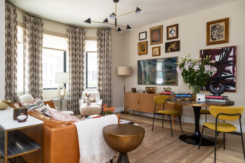 Decorated living room with gallery wall and brown leather couch