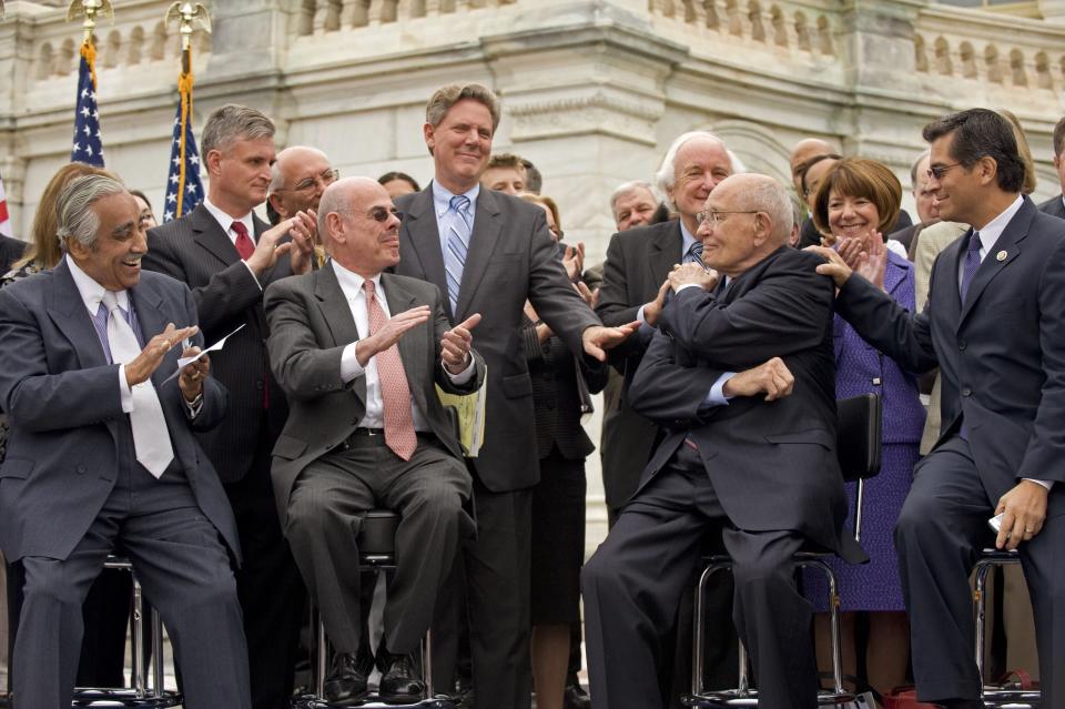 House Ways and Means Chairman Charles Rangel (D-N.Y.), House Energy Chairman Henry Waxman (D-Calif.), Rep. Frank Pallone Jr. (D-N.J.) and Rep. Xavier Becerra (D-Calif.), among&nbsp;others,&nbsp;applaud Dingell&nbsp;during an event on the West Front of the Capitol unveiling the long-awaited House Democratic health care overhaul package, known as the Affordable Care Act.