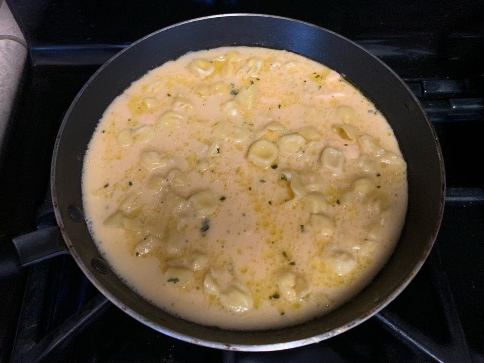 trader joe's pink sauce pasta cooking in pan on stove