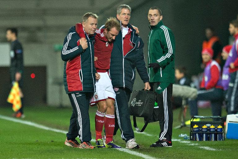 Denmark's Christian Eriksen (2nd L) is helped off the pitch after sustaining an injury during a pre-World Cup friendly against Norway, in Herning, Denmark, on November 15, 2013