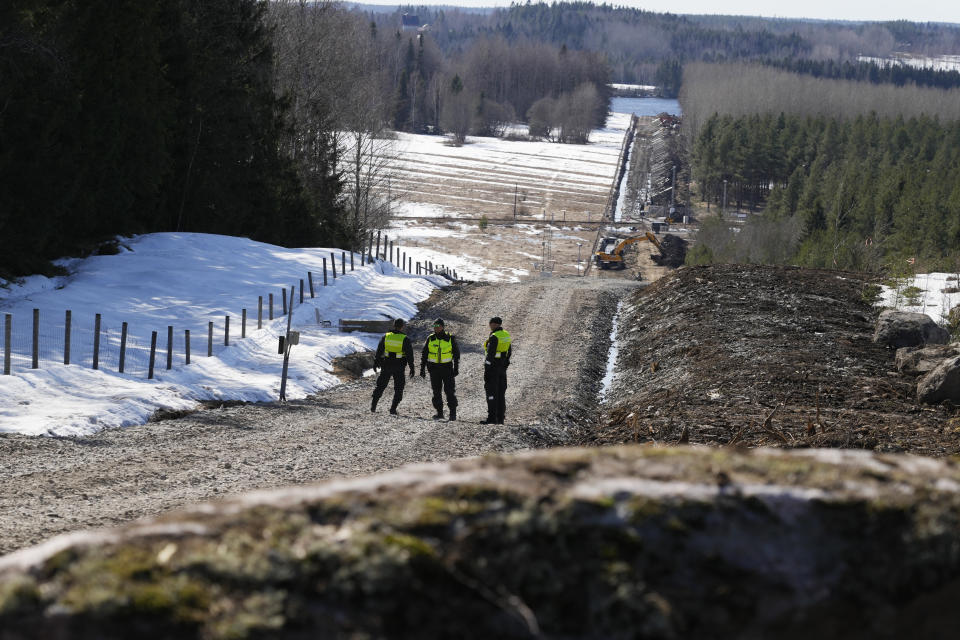 Finland's border guards stay at construction site of the border barrier fence between Finland and Russia near Pelkola border crossing point in Imatra, south-eastern Finland, Friday, April 14, 2023. (AP Photo/Sergei Grits)