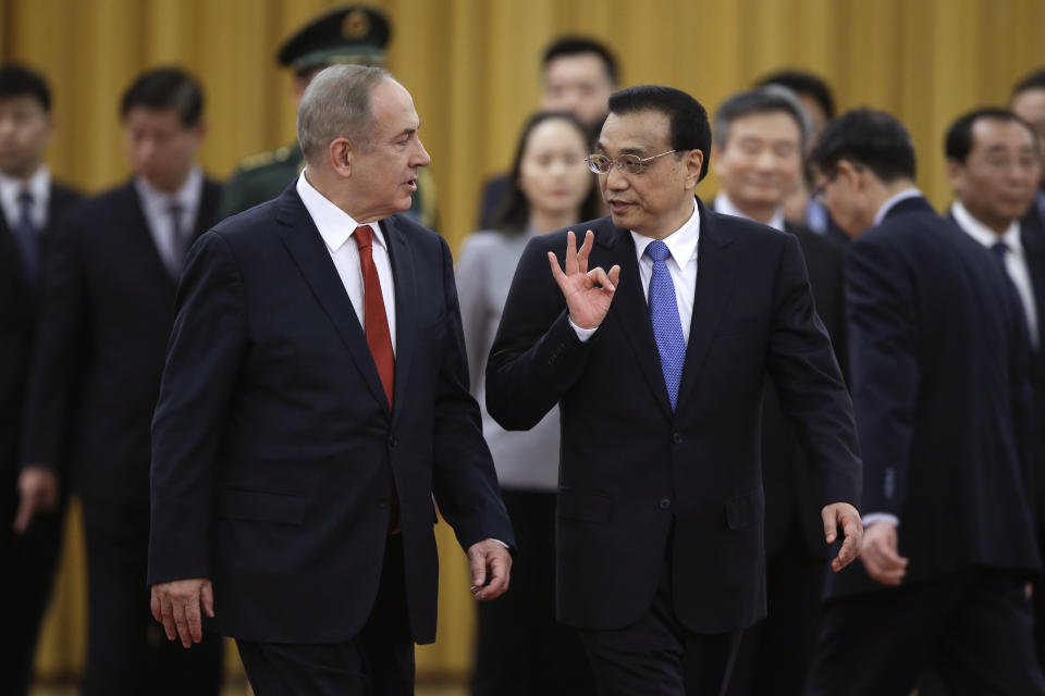 Israeli Prime Minister Benjamin Netanyahu, left, chats with Chinese Premier Li Keqiang as they arrive for a welcome ceremony at the Great Hall of the People in Beijing, Monday, March 20, 2017. (AP Photo/Andy Wong)