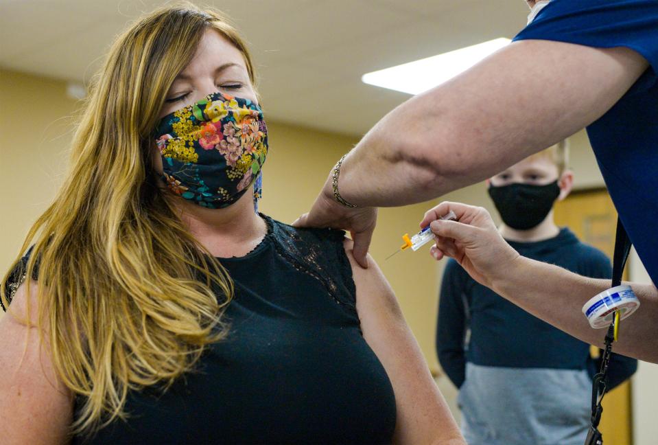 Kristi Scott receives her flu vaccine on Monday during the City-County Health Departments vaccine clinic at Great Falls College-MSU.