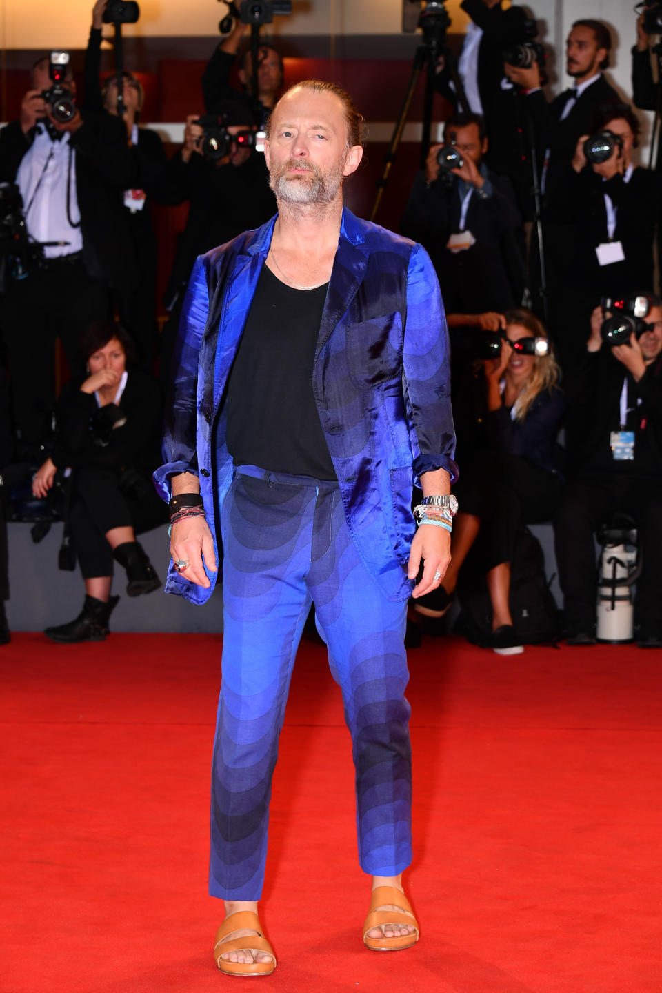 The Radiohead singer wears a bright blue and black suit for the "Suspiria" screening.