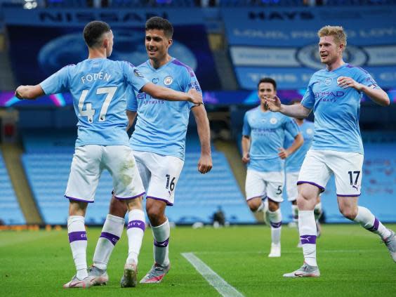 Phil Foden of Manchester City celebrates with Rodrigo and Kevin De Bruyne (2020 Pool)