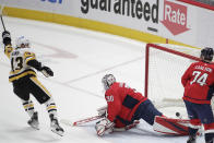 Pittsburgh Penguins' Danton Heinen, left, reacts after scoring against Washington Capitals goalie Ilya Samsonov (30) during the first period of an NHL hockey game, Friday, Dec. 10, 2021, in Washington. (AP Photo/Luis M. Alvarez)