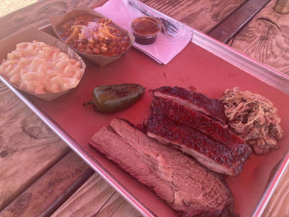 A three-meat platter with brisket, pulled pork and three spareribs, with two sides (macaroni and cheese and chili) sells for $24.99 at Smokin' Joe's Pit BBQ at Buddy's Beer Barn on the East Side.