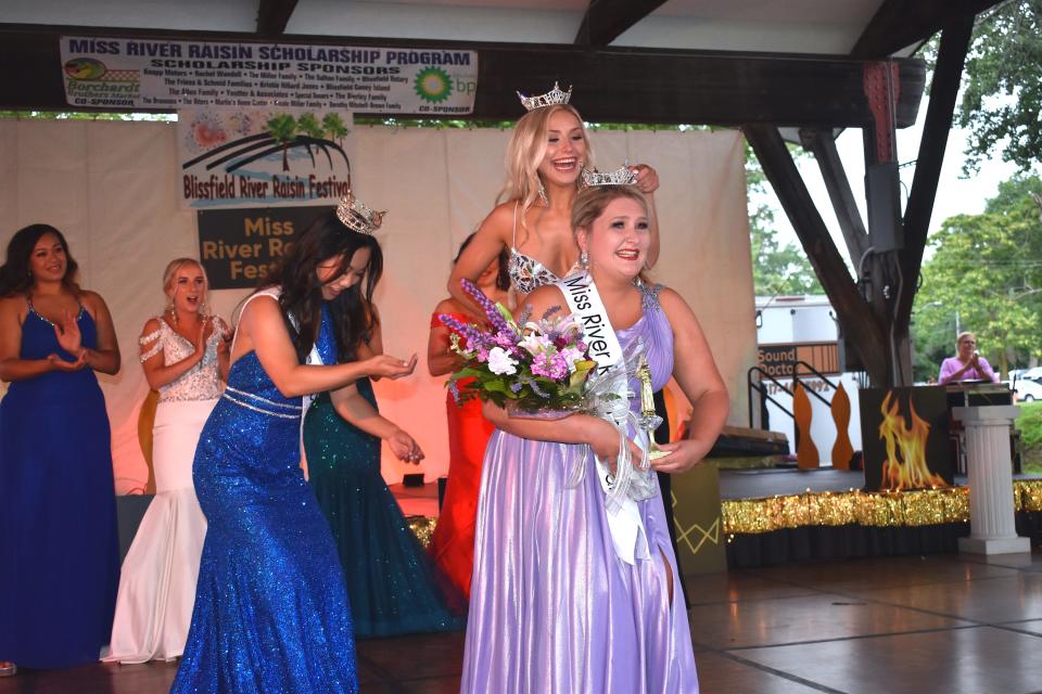 Laurel Hammis, 20, was crowned Miss River Raisin Festival 2021 out of a field of nine other Lenawee County women during Blissfield's River Raisin Festival in July 2021. Placing the crown on Hammis is 2019 and 2020 Miss River Raisin Festival Sydney Papenhagen of Blissfield. Miss Michigan 2021, Vivian Zhong, left, assists in the crowning ceremony.