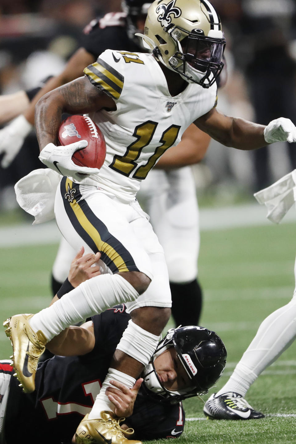 Atlanta Falcons kicker Younghoe Koo (7) tackles New Orleans Saints wide receiver Deonte Harris (11) during a kickoff during the first half of an NFL football game, Thursday, Nov. 28, 2019, in Atlanta. (AP Photo/John Bazemore)