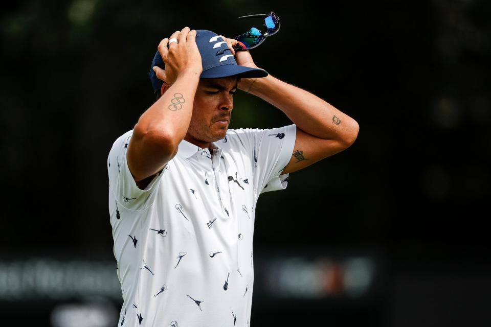 Rickie Fowler puts on his cap as he walks off the ninth green during Round 1 of the Rocket Mortgage Classic at the Detroit Golf Club in July.