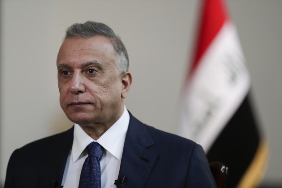 Iraqi Prime Minister Mustafa al-Kadhimi poses in his office during an interview with The Associated Press in Baghdad, Iraq, Friday, July 23, 2021. (AP Photo/Khalid Mohammed)