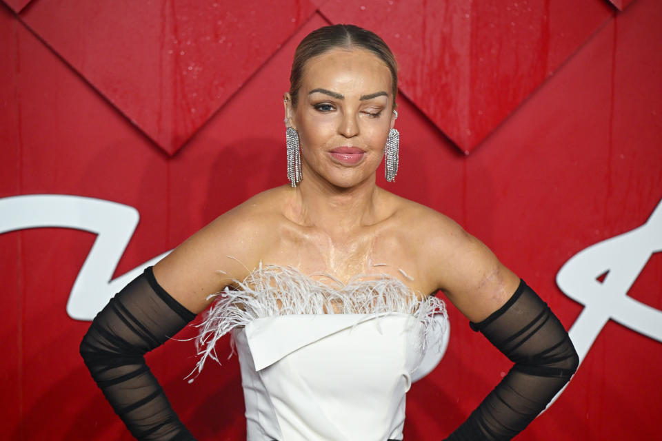 Katie Piper in a strapless dress featuring a fluffy neckline on red carpet