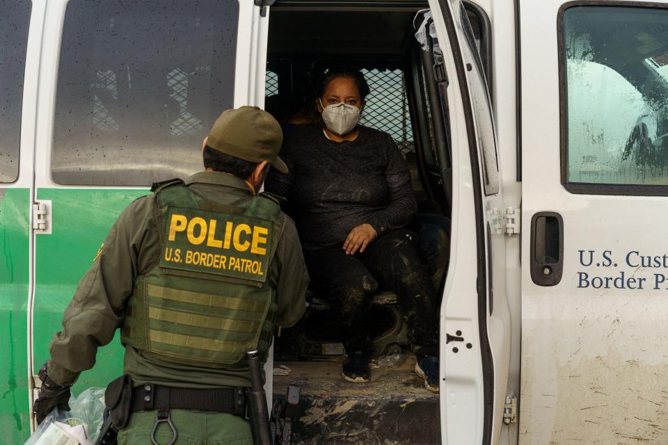 A U.S. Border Patrol agent processes a group of migrants in Sunland Park, New Mexico on July 22, 2021. / Credit: PAUL RATJE/AFP via Getty Images