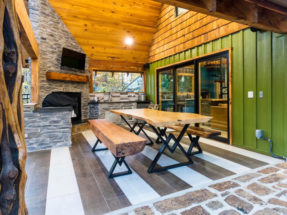 The outdoor kitchen and dining area of the poolhouse.