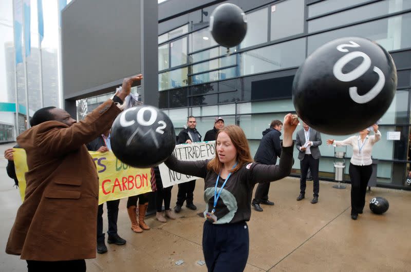 FILE PHOTO: Activists protest against the carbon dioxide emissions trading in front of the World Congress Centre Bonn, the site of the COP23 U.N. Climate Change Conference, in Bonn