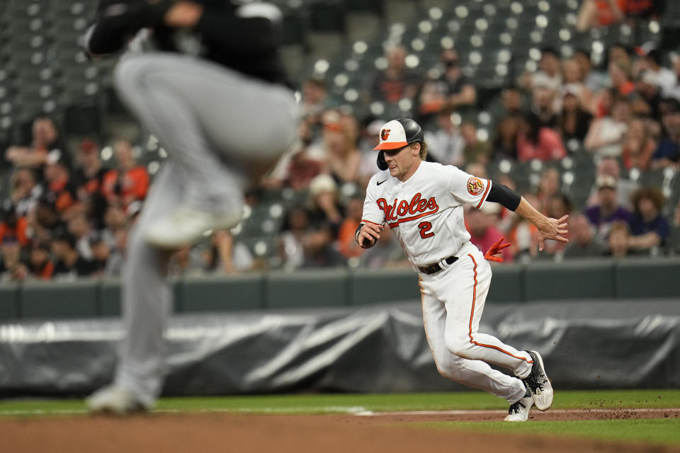 Chicago White Sox starting pitcher Michael Kopech, left, throws as Baltimore Orioles' Gunnar Henderson (2) makes a move while stealing second base during the first inning of a baseball game, Monday, Aug. 28, 2023, in Baltimore. (AP Photo/Julio Cortez)