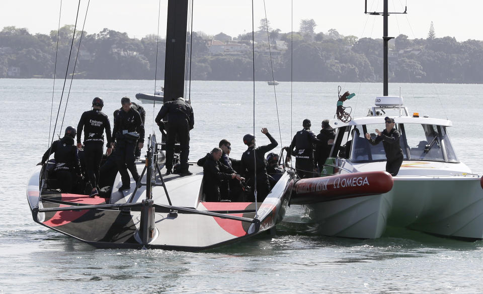 FILE - In this Sept. 18, 2019, file photo, New Zealand's America's Cup AC75 boat and crew leave their base at Auckland's Viaduct Harbour for a test sail on Waitemata Harbour, in Auckland, New Zealand. The futuristic present and storied past of the America’s Cup will converge from Friday, Jan. 15, 2021 at Auckland, New Zealand when racing begins to find the latest winner of the famous sailing trophy first contested in 1851. (AP Photo/Mark Baker, File)