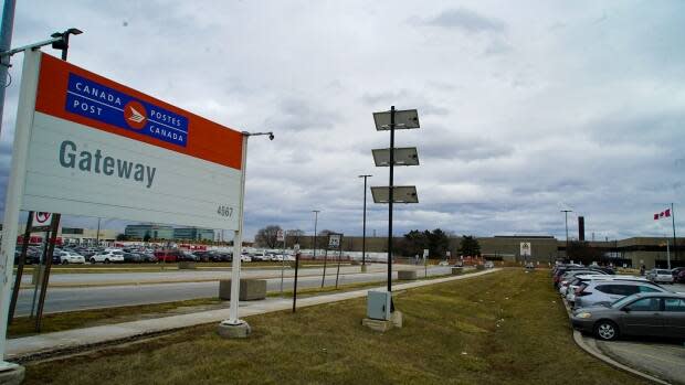 An exterior sign outside Canada Post Gateway West plant in Mississauga. Workers at this plant held a farewell party for a colleague just days before Peel Public Health partially shut it down. (Oliver Walters/CBC - image credit)