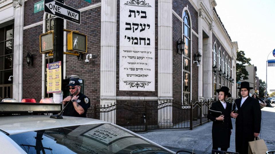 PHOTO: A member of the New York Police Department patrols in front of the synagogue Congregation Bais Yaakov Nechamia Dsatmar, Oct. 13, 2023, in Brooklyn. (Stephanie Keith/Getty Images)