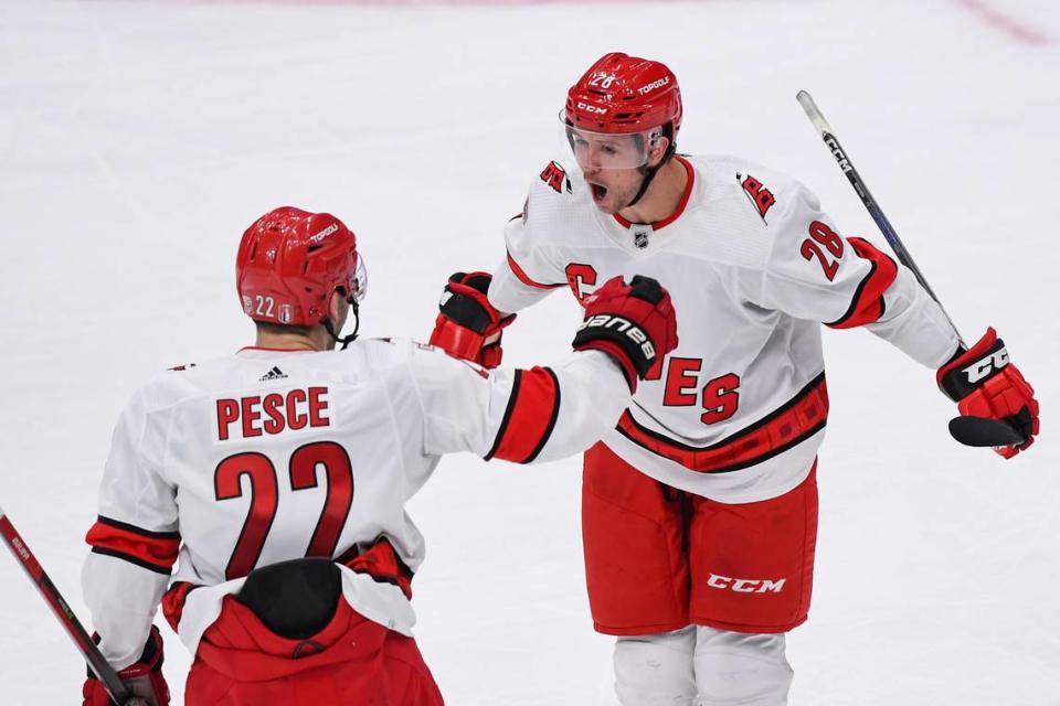 Carolina Hurricanes left wing Mackenzie MacEachern (28) celebrates his goal against the New York Islanders with Carolina Hurricanes defenseman Brett Pesce (22) during the third period in game four of the first round of the 2023 Stanley Cup Playoffs at UBS Arena.