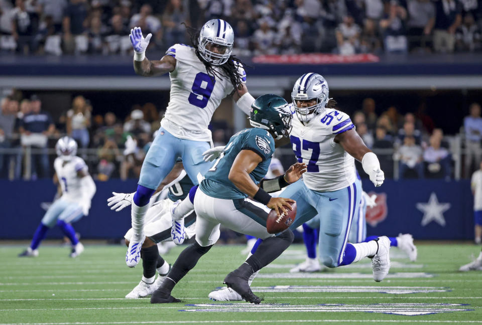 Sep 27, 2021; Arlington, Texas, USA; Dallas Cowboys middle linebacker Jaylon Smith (9) and defensive tackle Osa Odighizuwa (97) pressure Philadelphia Eagles quarterback Jalen Hurts (1) during the game at AT&T Stadium. Mandatory Credit: Kevin Jairaj-USA TODAY Sports