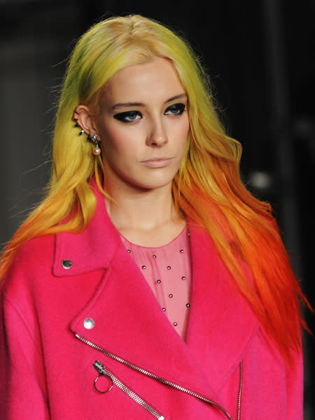<b>Moschino </b><br><br>Models sported bright dyed locks, smokey eyes and nude lips at the punk inspired show.<br><br>© Getty