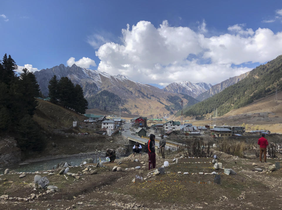 Relatives of suspected rebels killed by government forces visit a graveyard in Sonamarg, a remote mountainous resort in Indian controlled Kashmir, Nov.3, 2020. The picturesque tourist spot where a small hill meant for the bodies of rebels started small in April has since nearly filled up. Indian authorities in a new controversial policy in 2020 started to consign blood-soaked bodies of scores of Kashmiri rebels to unmarked graves, denying the mourning families a proper funeral and a burial at their own ancestral home graveyards. (AP Photo/Aijaz Hussain)