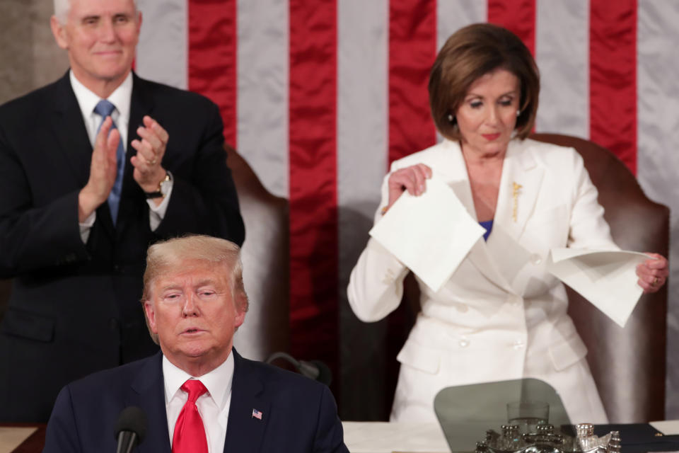 Speaker of the House Nancy Pelosi, seen with then-President Donald Trump in the foreground and flanked by then-Vice President Mike Pence, rips up a copy of Trump&#x002019;s speech.