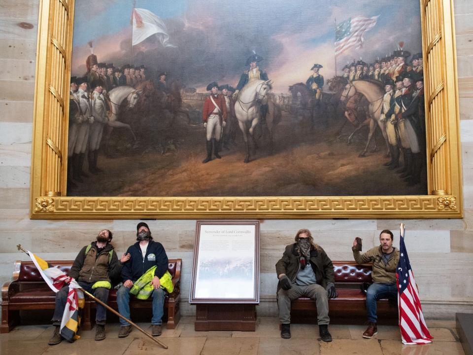 Pro-Trump supporters gaze up at an artwork in the US Capitol