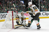 Vegas Golden Knights goaltender Adin Hill (33) defends against a shot with help from defenseman Alex Pietrangelo (7) against pressure from Dallas Stars center Luke Glendening, right rear, in the first period of Game 6 of the NHL hockey Stanley Cup Western Conference finals, Monday, May 29, 2023, in Dallas. (AP Photo/Tony Gutierrez)