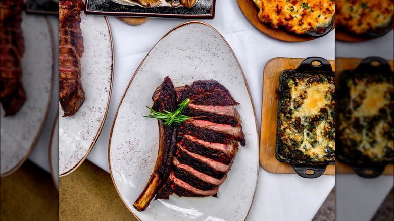 sliced steak white speckled plate