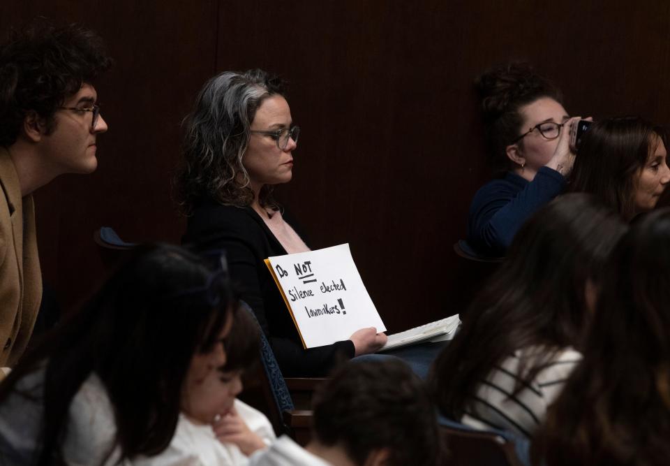 Allison Polidor holds a sign reading “Do Not Silence Elected Lawmakers!” during a House Rules Committee meeting at Cordell Hull State Office Building in Nashville, Tenn., Monday, Jan. 8, 2024.