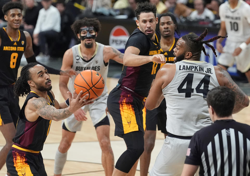 Arizona State guard Frankie Collins, front left, pulls in the ball after Arizona State guard Jose Perez, front center, lost control of it while battling with Colorado center Eddie Lampkin Jr. (44) in the second half of an NCAA college basketball game Thursday, Feb. 8, 2024, in Boulder, Colo. (AP Photo/David Zalubowski)